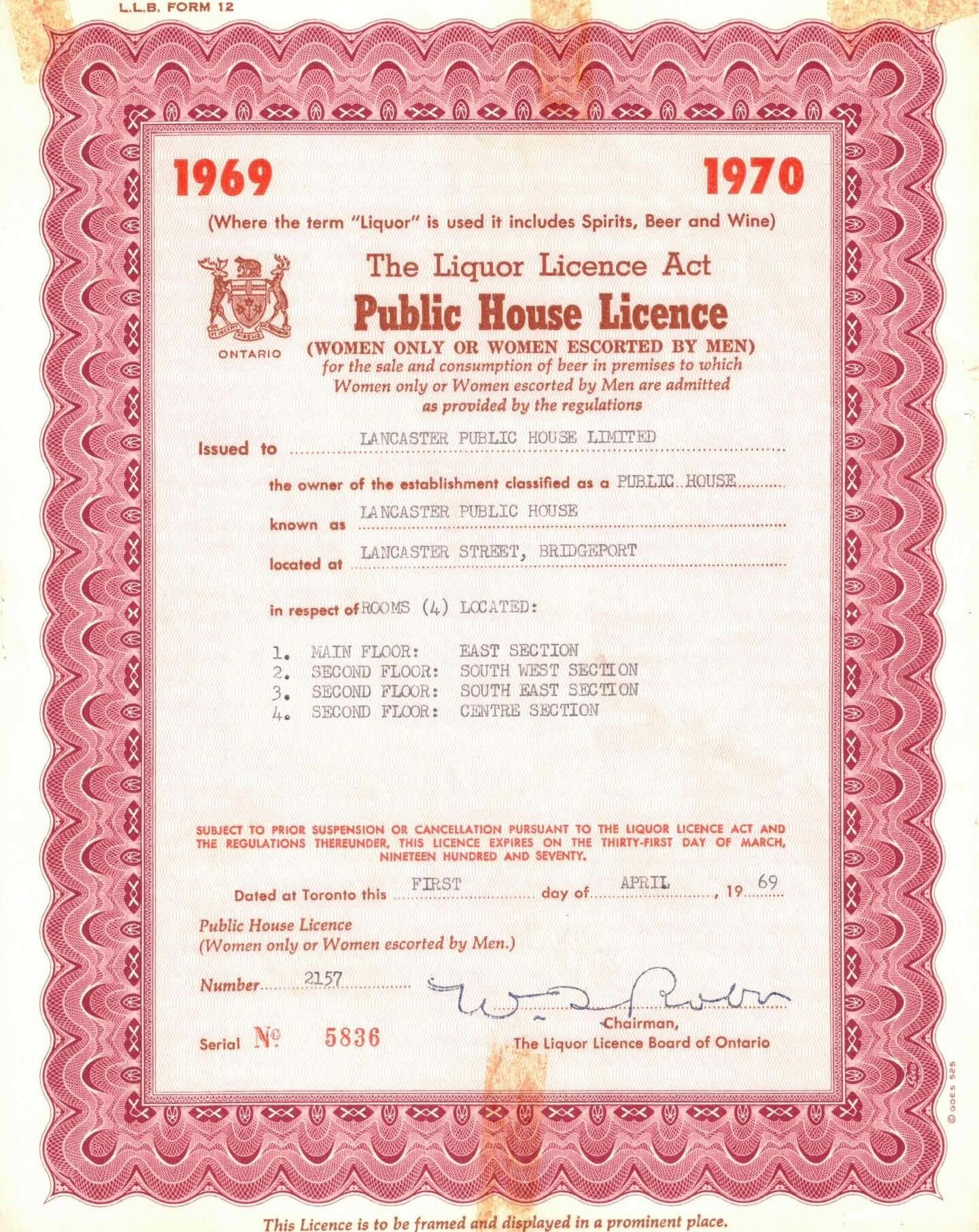 A framed 1969–1970 Ontario Liquor Licence issued to Lancaster Public House, outlining the era’s gender‑restricted “Women only or Women escorted by Men” regulations; this historic licence was gifted to The Lancaster Smokehouse by the Kirby family and is preserved as part of the restaurant’s heritage collection.